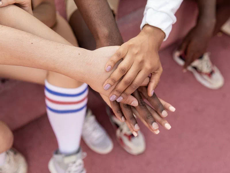 mindful-movements.org-about-p2-diverse-group-of-athletes-hands-together