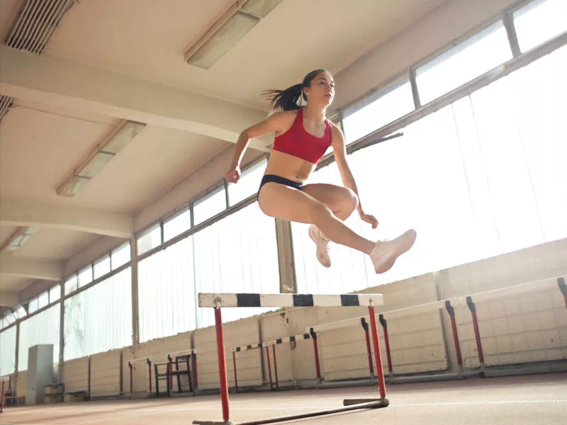 mindful-movements.org-about-p2-young-female-athlethe-running-jumping-hurdles