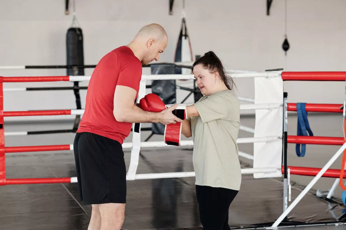mindful-movements.org-activities-crsl-boxing-young-female-with-down-syndrome-putting-on-boxing-gloves