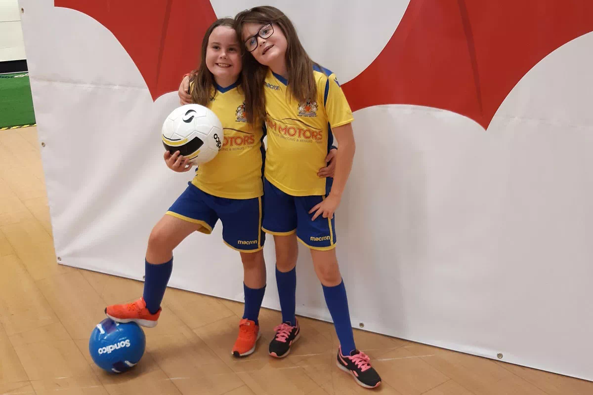 mindful-movements.org-activities-crsl-football-fiesta-two-young-girls-with-footballs
